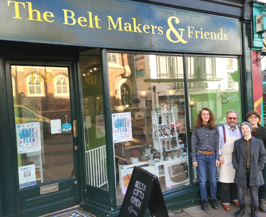 Shop front with Buckfield group, l-r: Robin, Mark, Gus, Marie