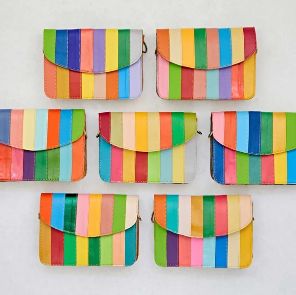 7 Crossbody Shoulder Bags with Vertical Stripe, as a flat-lay. This demonstrates the range of variation in the product